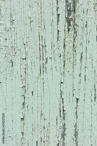 Green paint peeling off a wood