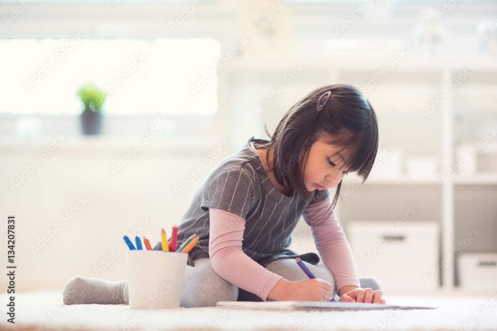 Pretty happy little japanese girl drawing with pencils at home Pretty happy little japanese girl drawing with pencils at home