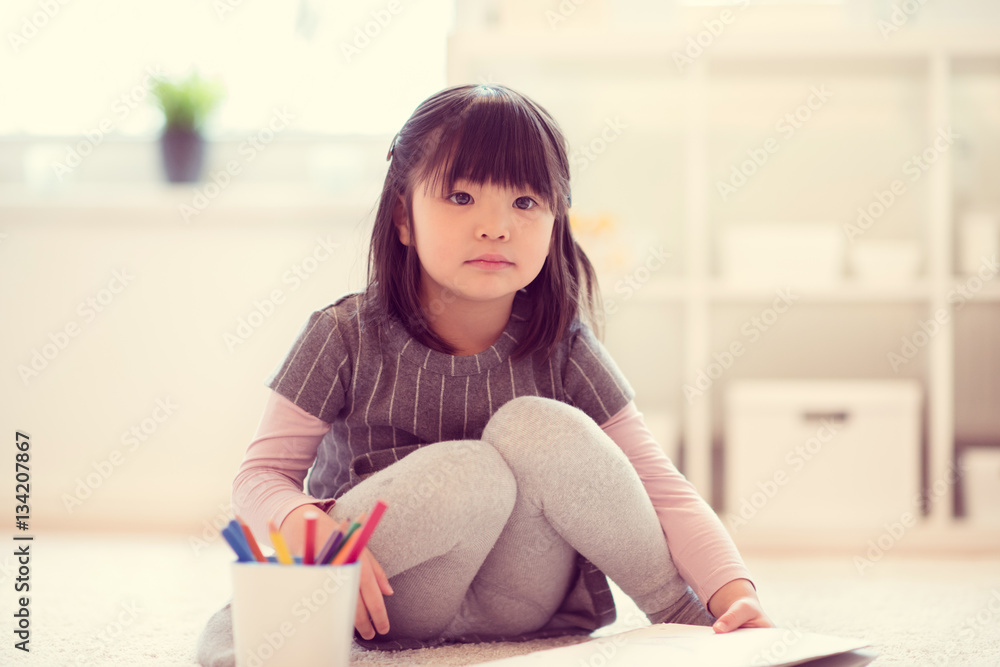 Pretty happy little japanese girl drawing with pencils at home Pretty happy little japanese girl drawing with pencils at home