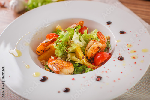 Caesar salad with shrimps and iceberg leaves