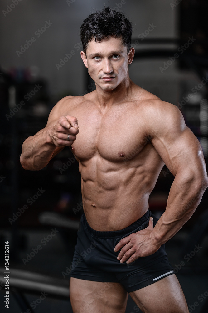 Handsome bodybuilder training in the gym sexy man lift dumbbells Handsome bodybuilder training in the gym sexy man lift dumbbells