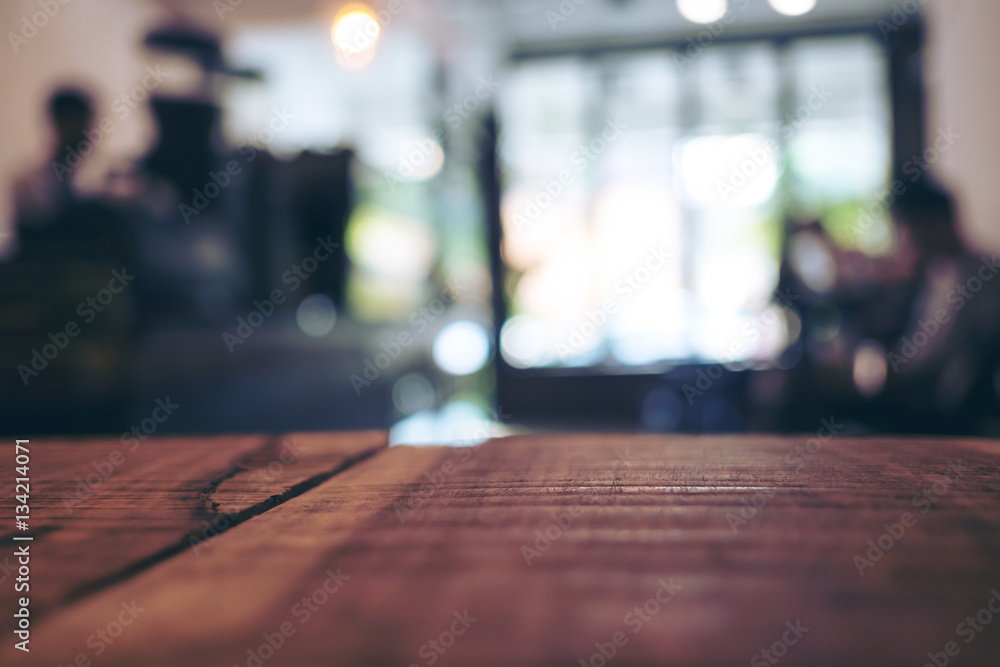 Wooden table in cafe with blur bokeh vintage backgroud