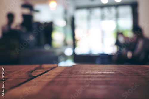 Wooden table in cafe with blur bokeh vintage backgroud