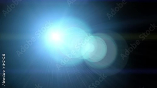 Bright light with lens flare moving. Background with spotlight beam. 