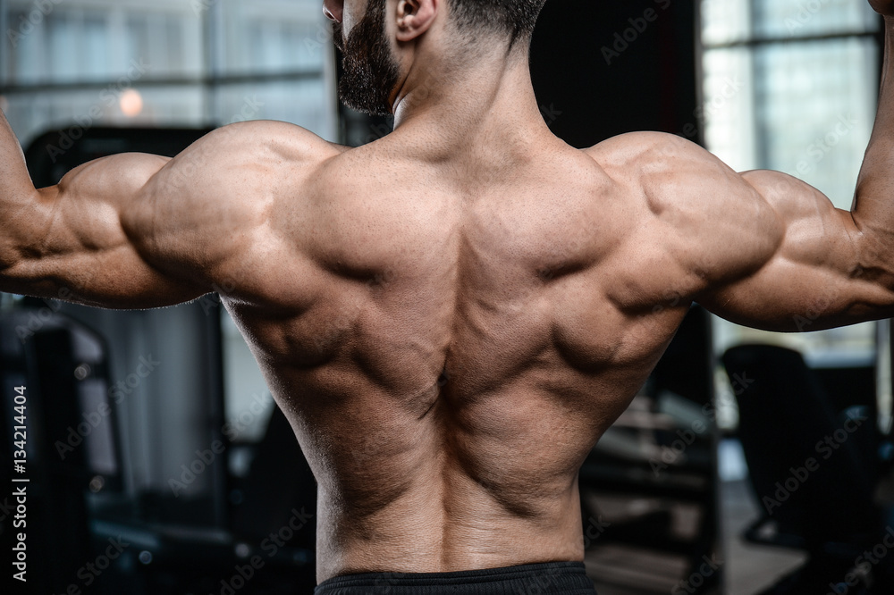 Fitness instructor handsome man in the gym gain muscle Fitness instructor handsome man in the gym gain muscle