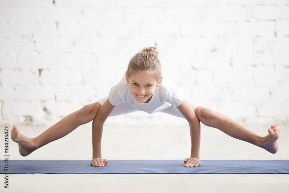 Smiling girl child practicing yoga, standing in titibhasana exercise,  Tittibhasana, Firefly pose, working out, wearing sportswear, t-shirt,  pants, indoor full length, white loft studio background Stock Photo | Adobe  Stock