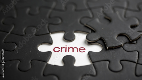 Word crime under jigsaw puzzle piece