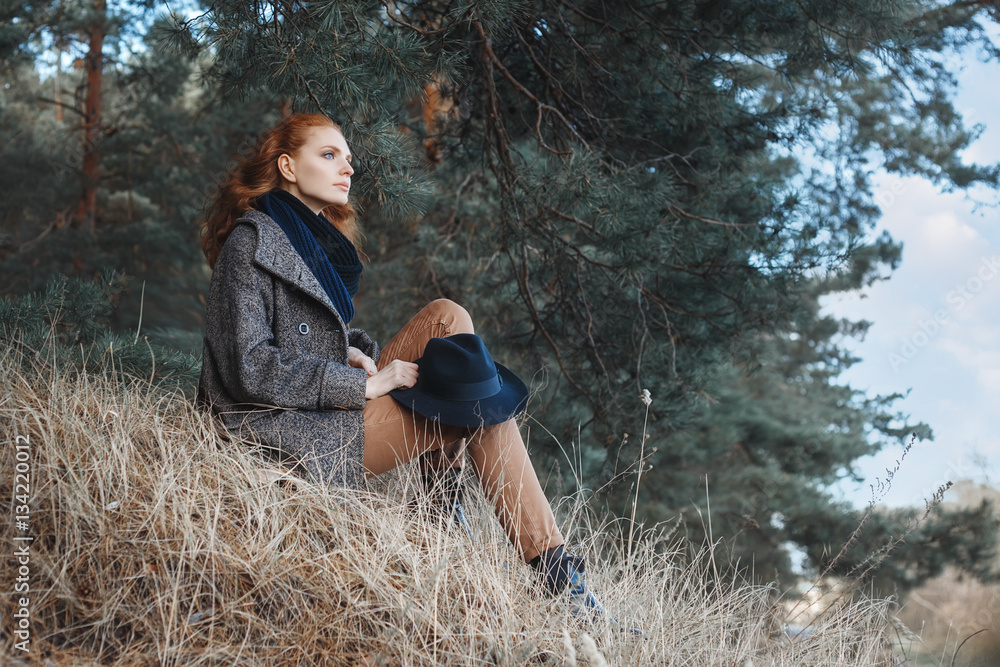 woman with curly red hair outdoors woman with curly red hair outdoors