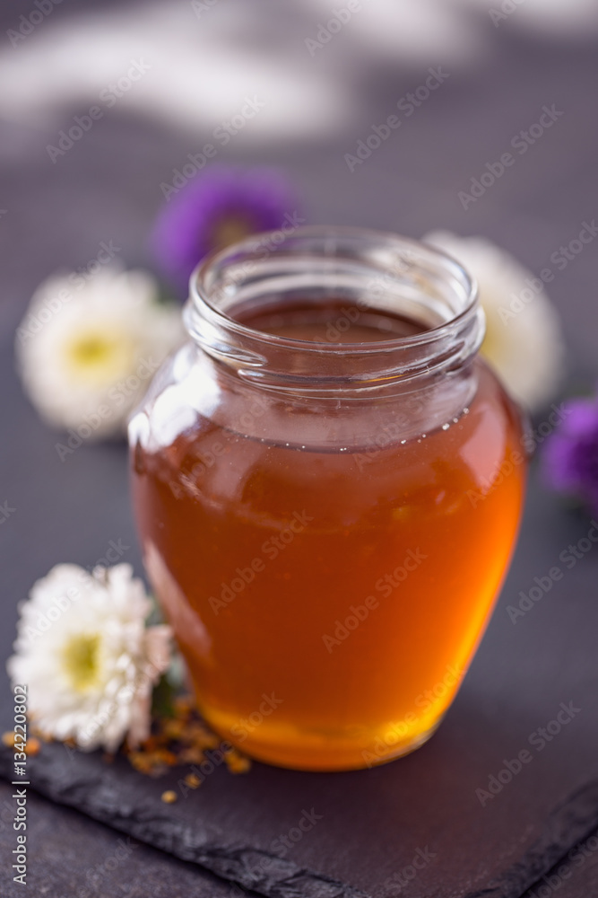Sweet natural honey in the glass jar. Sweet natural honey in the glass jar.