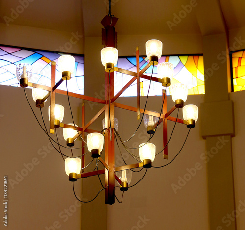 chandelier with many light bulbs inside a place of worship