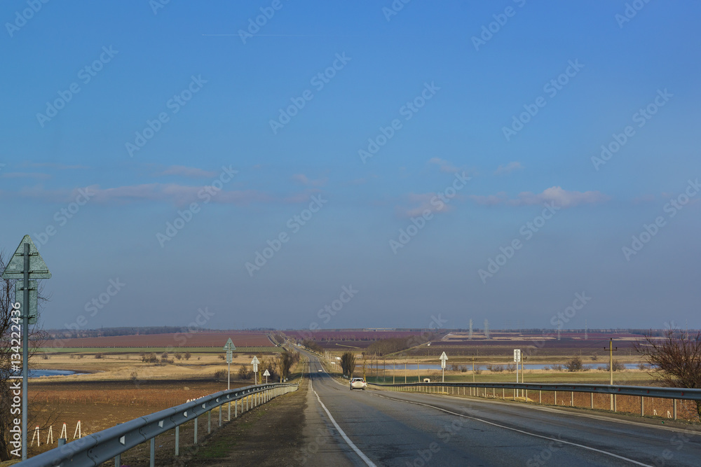 Naklejka premium Winter road into the distance over the hills of the Taman Peninsula