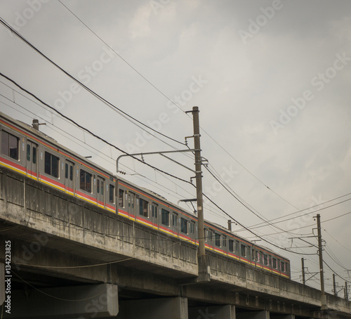 a commuter line passing trough an overpass photo taken in Jakarta Indonesia