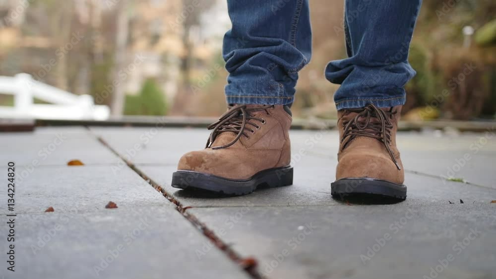 A slow motion shot of a construction worker dropping a lead pipe on his steel toed boots. A slow motion shot of a construction worker dropping a lead pipe on his steel toed boots.