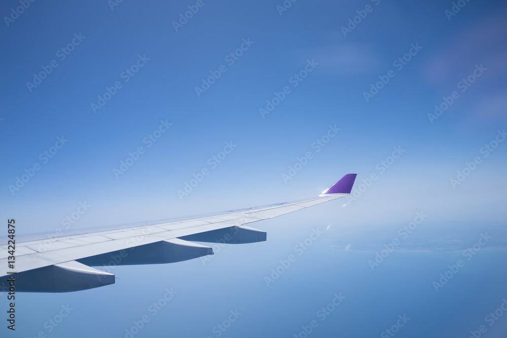 Clouds and sky as seen through window of an aircraft Clouds and sky as seen through window of an aircraft