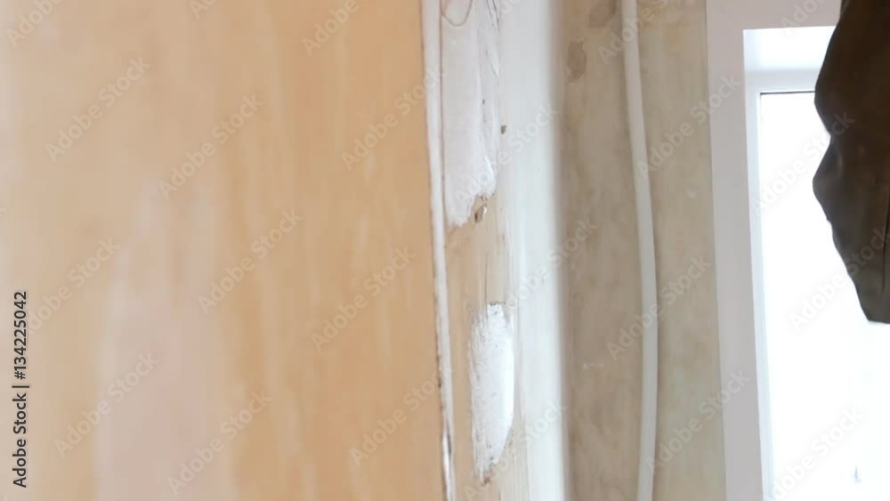 Man plastering wall with spatula Man plastering wall with spatula