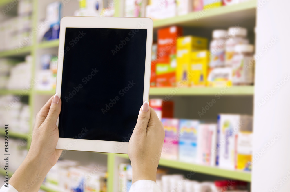 Online pharmacy concept, pharmacist holding tablet Online pharmacy concept, pharmacist holding tablet