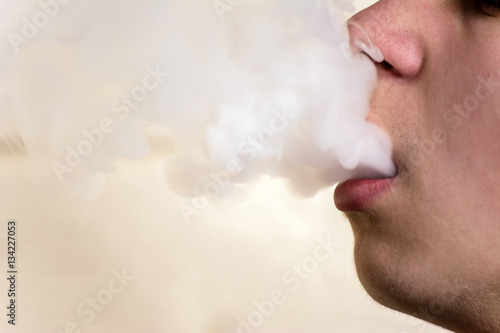 man and smoke from mouth