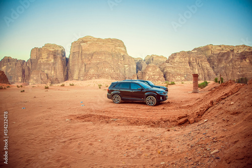 Obraz na płótnie Black jeep car in the desert near the mountains in Petra, Wadi Rum. Jordan w salonie