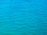 Blue tranquil sea water background.