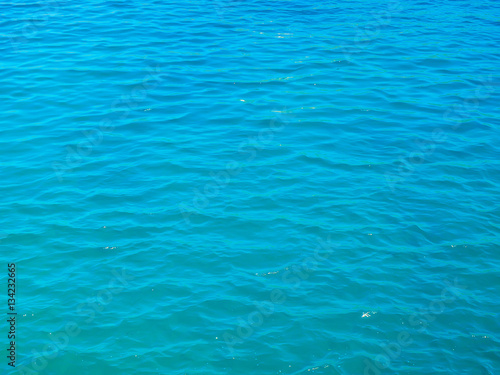 Blue tranquil sea water background. © tuulijumala