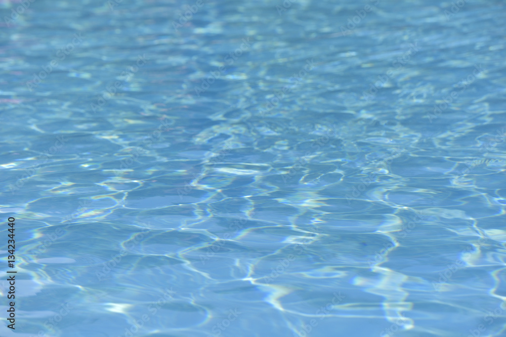 Beautiful ripple water surface with sun reflection in swimming pool Beautiful ripple water surface with sun reflection in swimming pool