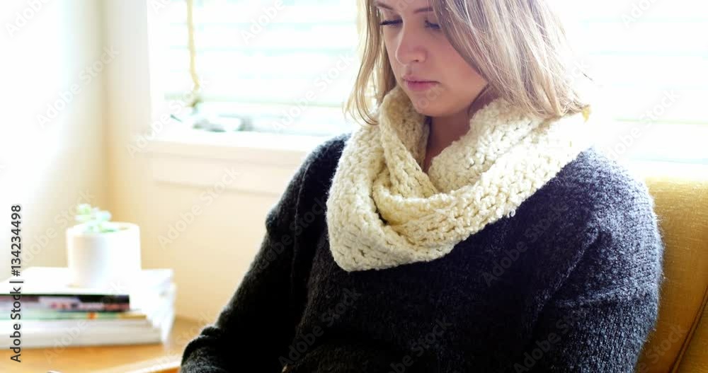 Beautiful woman using digital tablet in living room Beautiful woman using digital tablet in living room