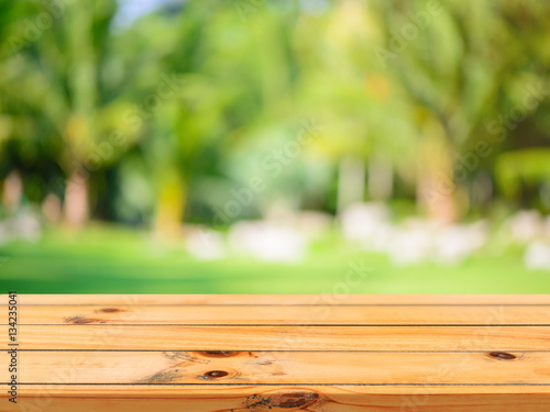 Fototapeta Naklejka Na Ścianę i Meble -  Wooden board empty table in front of blurred background. Perspective brown wood table over blur trees in forest background - can be used mock up for display or montage your products. spring season.