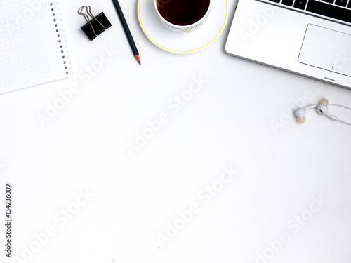 Modern white office computer Desk, mobile with a black screen on a laptop, and a Cup of tea. Top view with copy space, flat lay.
