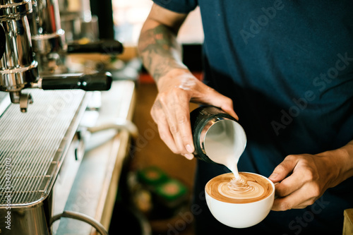 Baristas are coffee,by tattooed barista arm photo