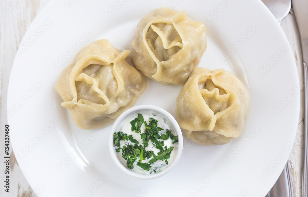 Traditional Turkish manti with sour cream sauce