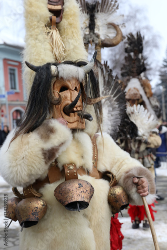 Breznik, Bulgaria - January 21, 2017: Unidentified man with traditional Kukeri costume are seen at the Festival of the Masquerade Games Surova in Breznik, Bulgaria
