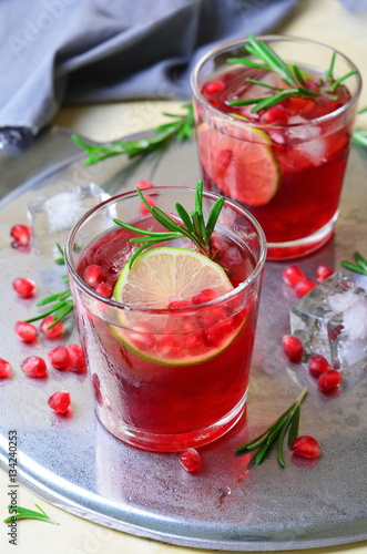 Pomegranate Cocktail Decorated with Lime, Rosemary and Ice, Cold Drink