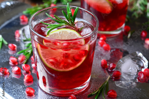 Pomegranate Cocktail Decorated with Lime, Rosemary and Ice, Cold Drink
