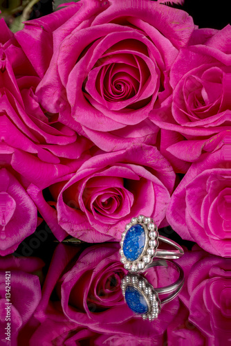 Beautiful ring with roses as a background