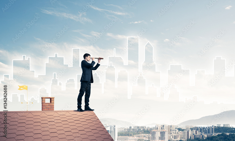 Engineer man standing on roof and looking in spyglass. Mixed media Engineer man standing on roof and looking in spyglass. Mixed media