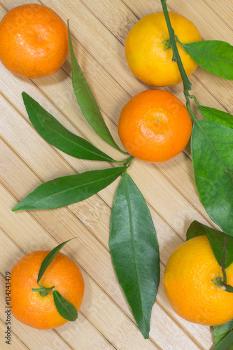 Branch with tangerines on a table