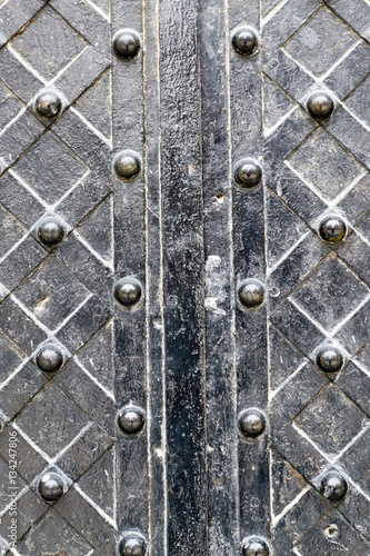geometric pattern with studs on old vintage metal door