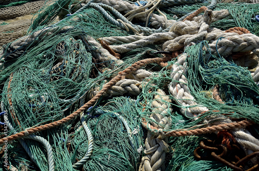 fishing nets deposited on the dock to dry