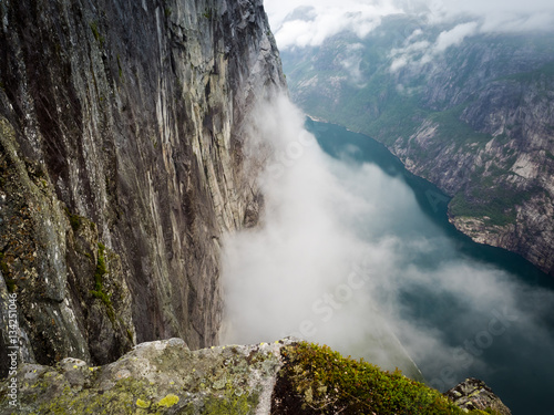 Cliff Edge view over Norwegian fjord with cloud inversion below -  Kjerag, Norway