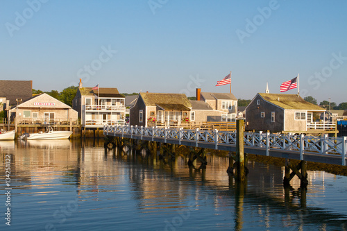 Nantucket harbor houses early morning with flags