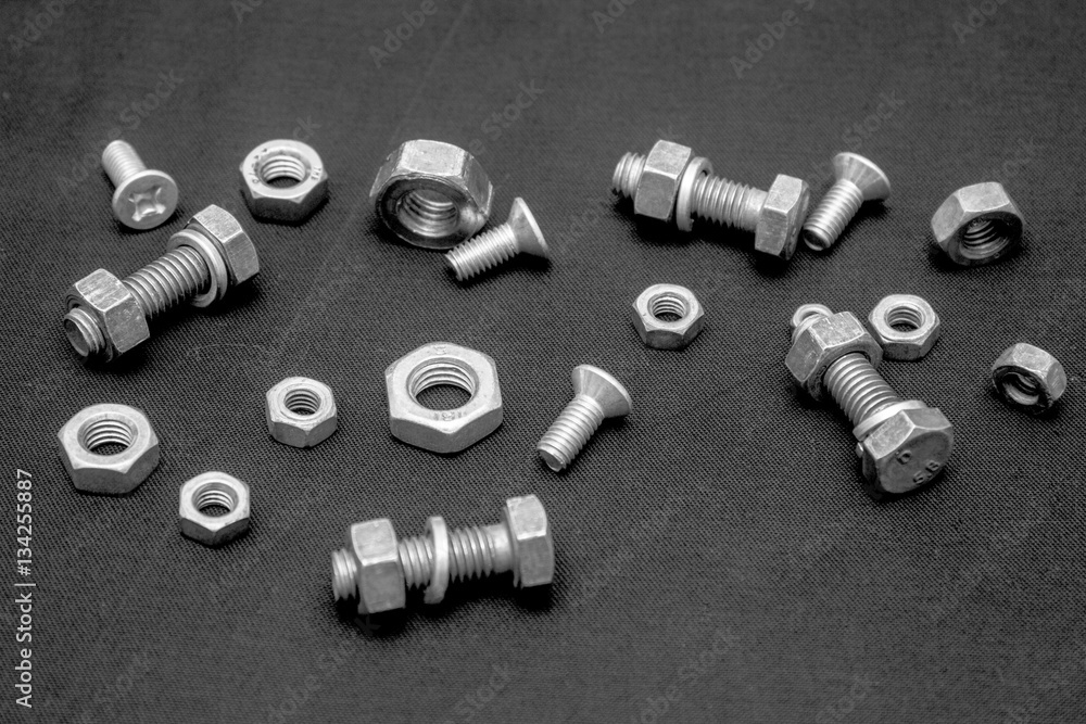 Nuts and bolts, dark background Nuts and bolts, dark background