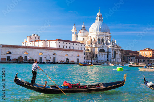Fototapeta Naklejka Na Ścianę i Meble -  Grand Canal with gondola against Basilica Santa Maria della Salute in Venice, Italy
