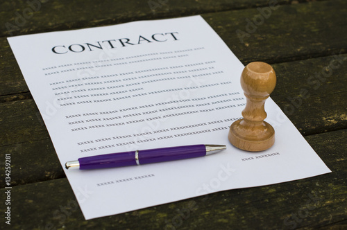 Pen and stamp on a filled contract