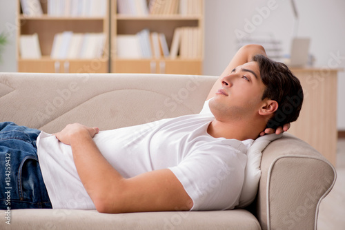 Young man sleeping in sofa couch