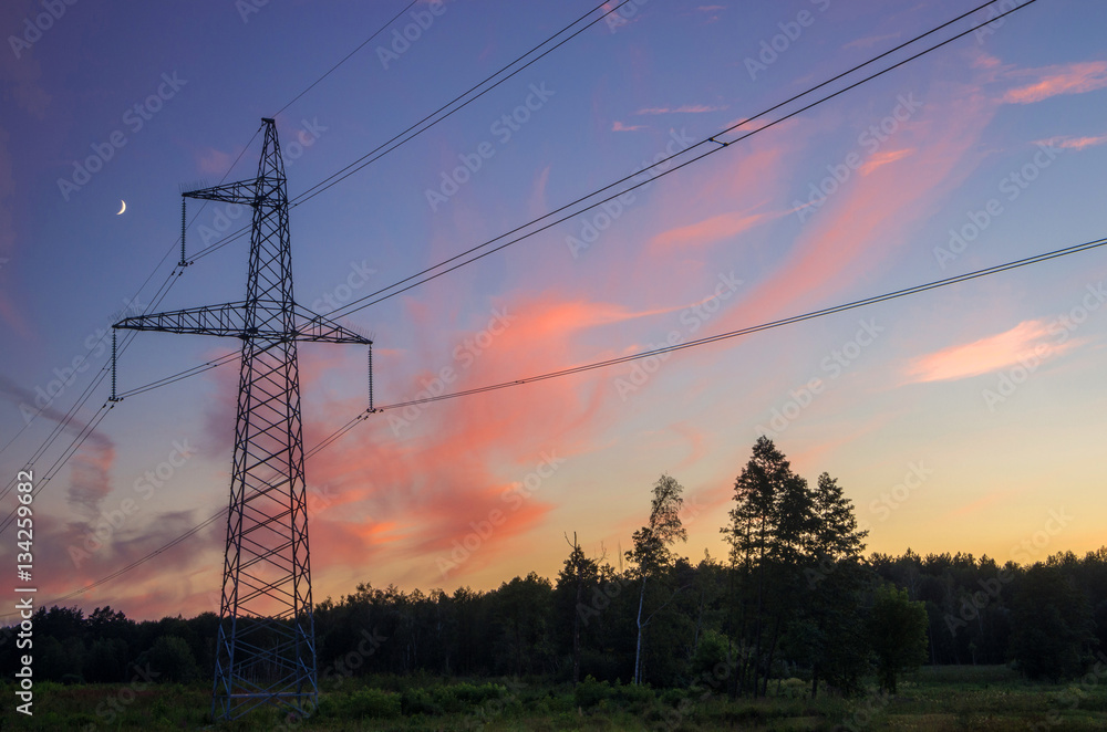  Electricity pylons on the field – sunset time shot.
