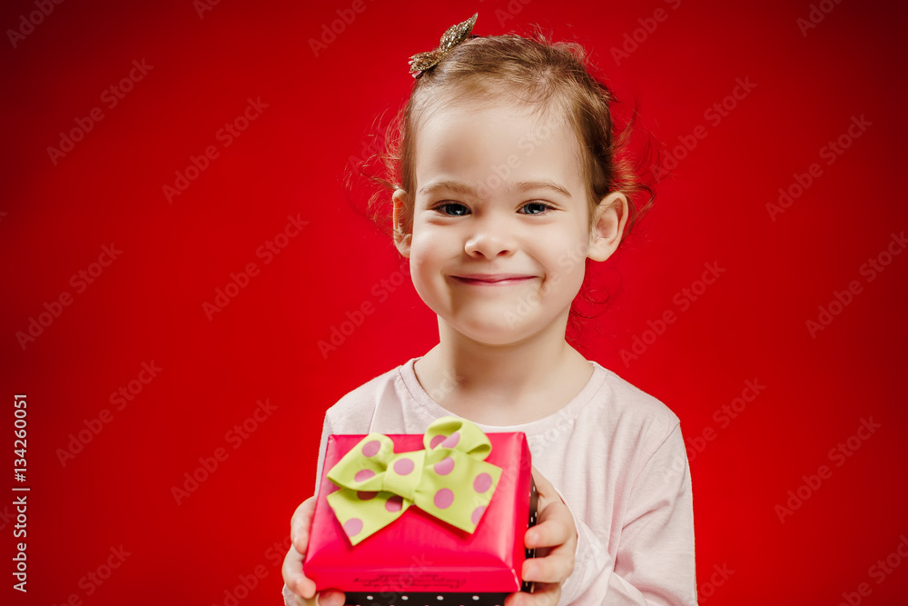 pretty and smiling girl holding a gift in their hands pretty and smiling girl holding a gift in their hands