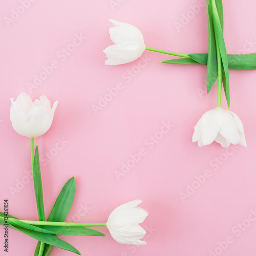 Fototapeta Naklejka Na Ścianę i Meble -  Floral bouquet with white tulips on pink background. Flat lay, top view. Valentines Day background. Floral frame.