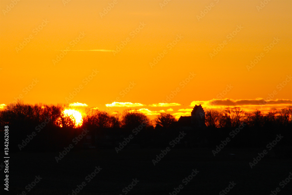 sunrise with a church in silhouette so beautiful in January sunrise with a church in silhouette so beautiful in January