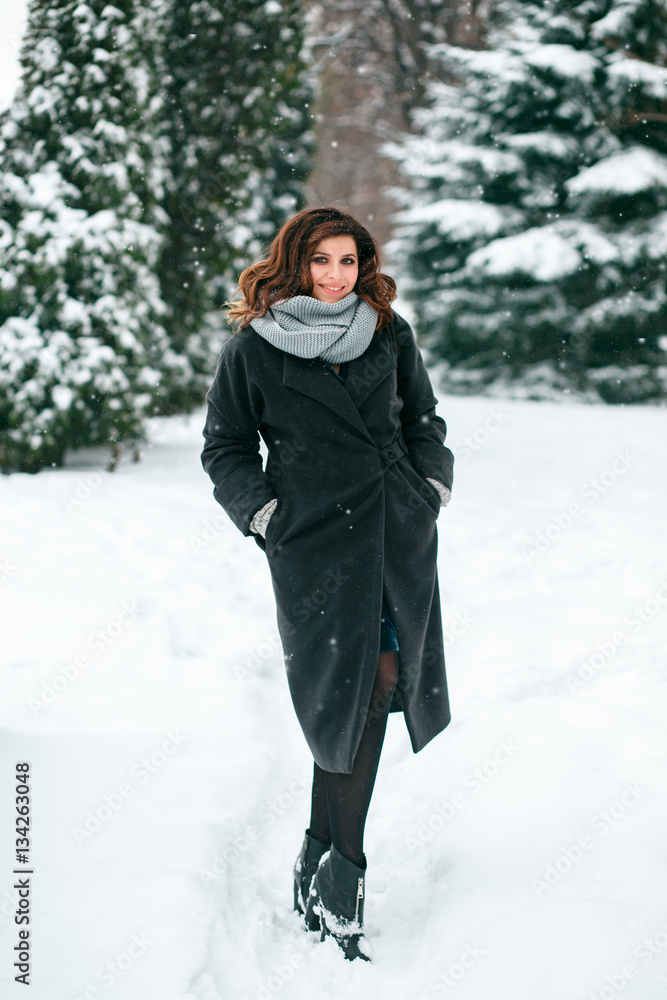 Big and beautiful girl posing on the street. Model wearing stylish warm clothes. Background park. Big and beautiful girl posing on the street. Model wearing stylish warm clothes. Background park.