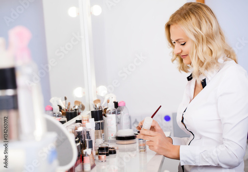 Makeup artist at his workplace in the mirror preparing tools to get started. Pending customer. Beauty salon.